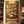 Gold Brew coffee bag with decorative design on a wooden surface with coffee beans.